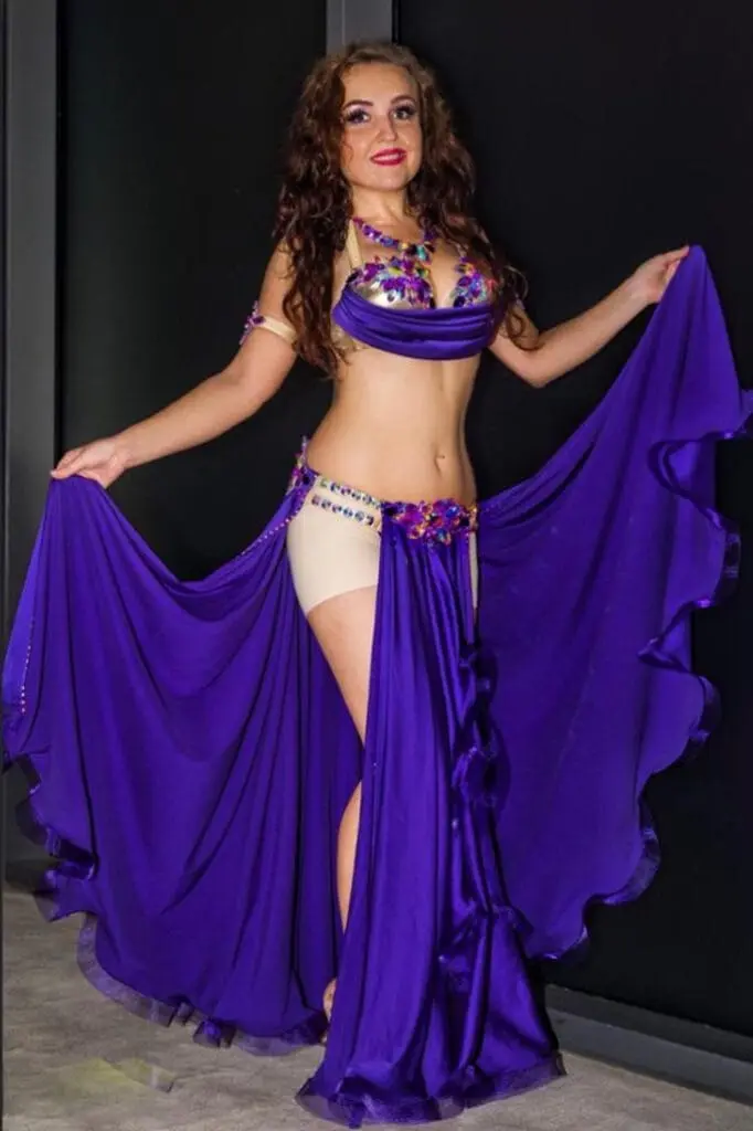 Belly dancer spreading a long purple skirt