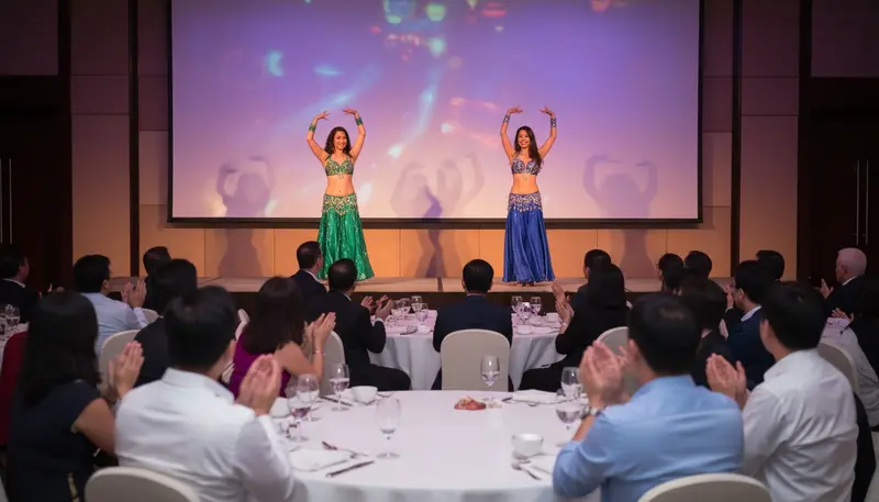 Two belly dancers performing on stage at a company dinner and dance in a Singapore hotel ballroom